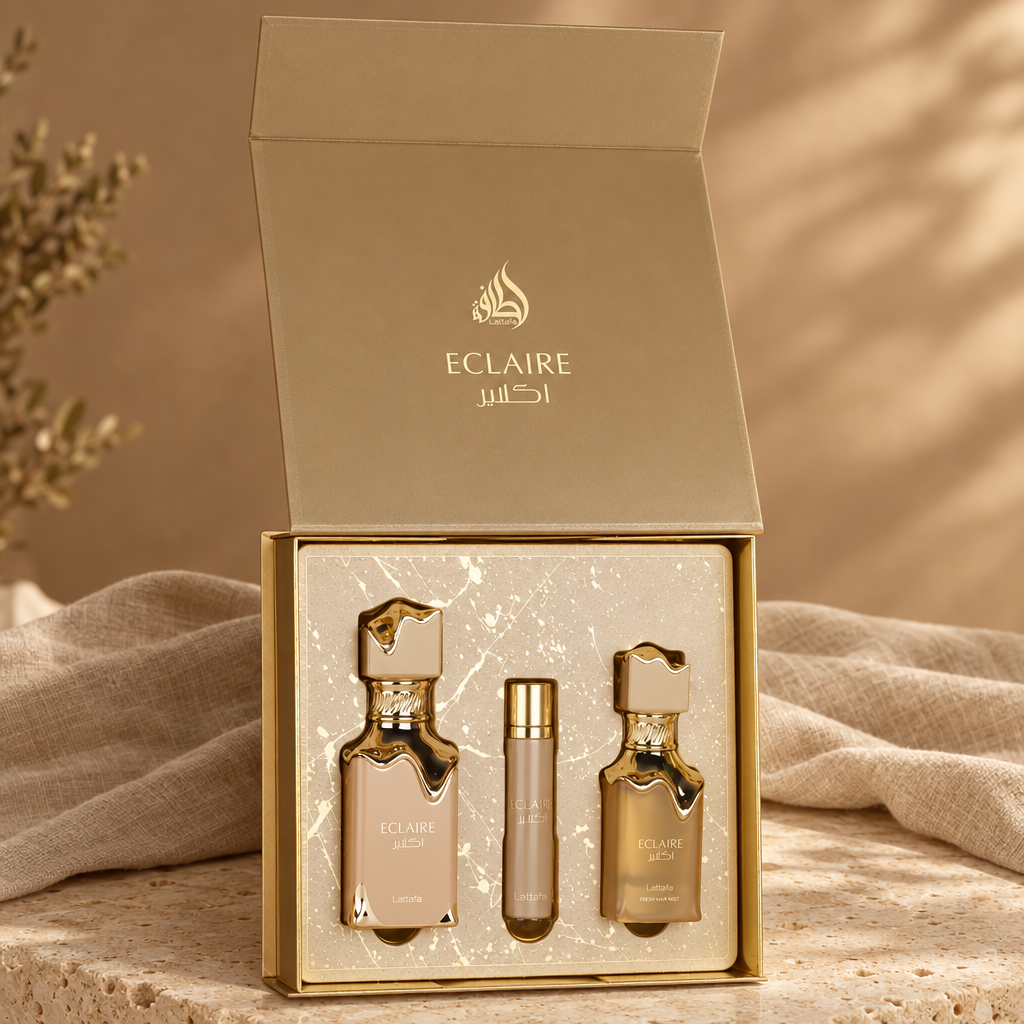 Lattafa Eclaire cadeauset op een stenen oppervlak met beige linnen en warm daglicht